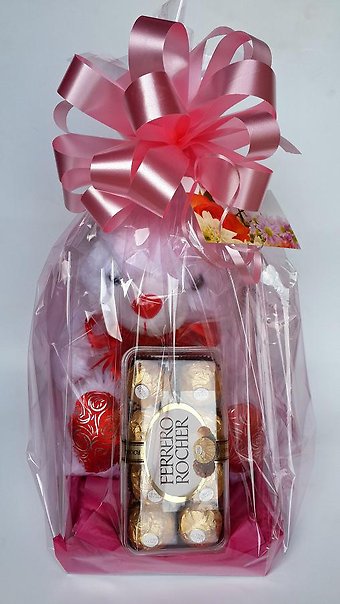 Gift wrapped teddy bear and chocolate